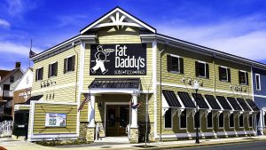 A yellow and black building for Fat Daddy's Restaurant
