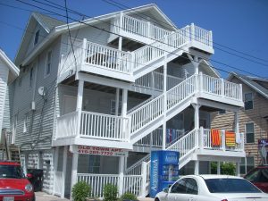 A repaired 8th street building with new white decking and stairs