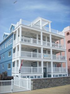A newly revitalized blue building with white porches