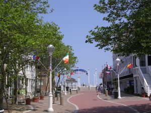 Streetlamps with flags and a winding brick path