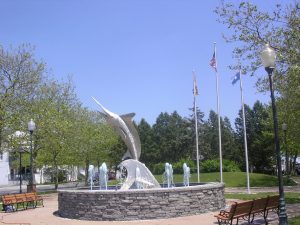 A water feature with a white marlin statue